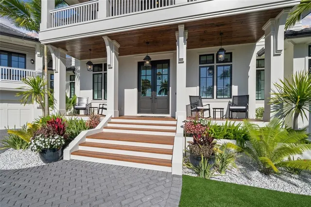 a living room with fireplace furniture and a large window