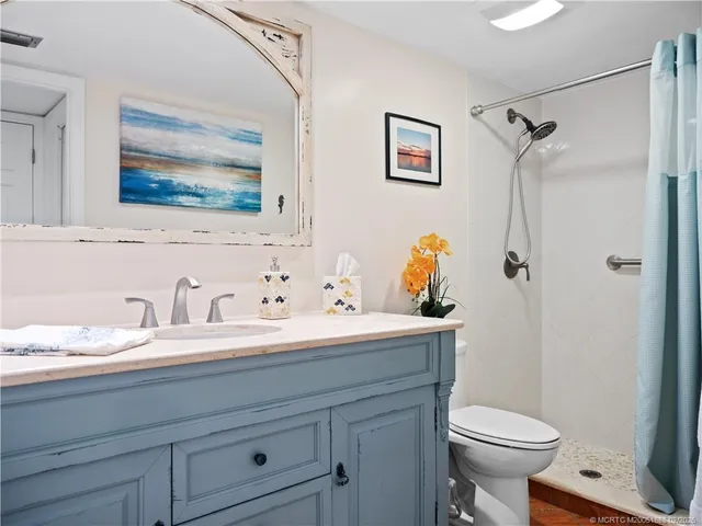 a bathroom with a sink toilet and shower