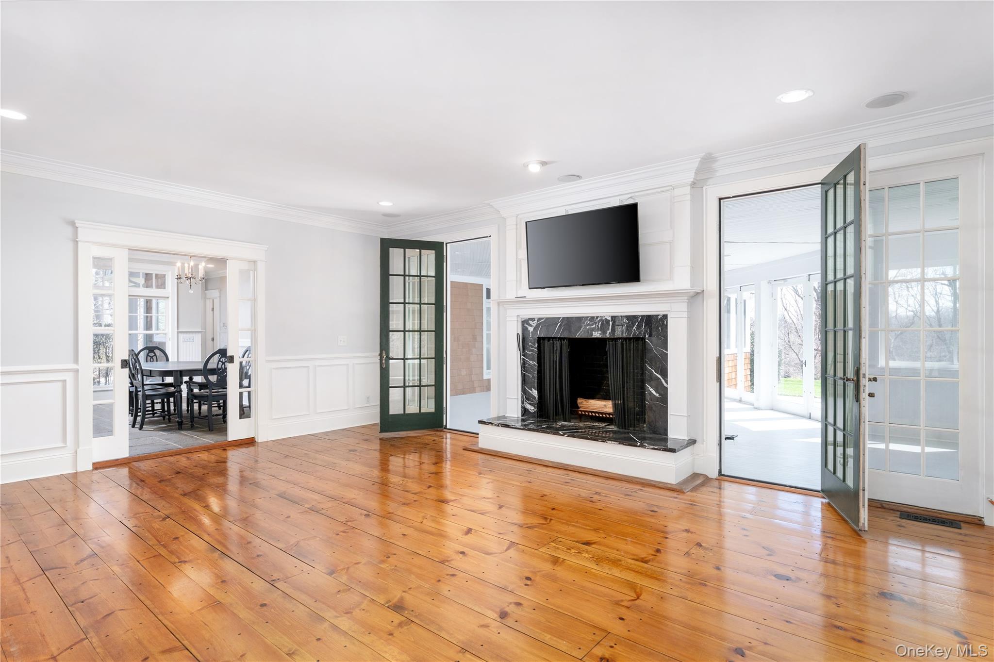 9 Old Field Road Setauket, NY 11733 - Photo 18 of 50 Generously Proportioned Den With Wood Burning Fireplace With Pocket Doors To Kitchen and French Doors To Sunroom and Enclosed Porch.