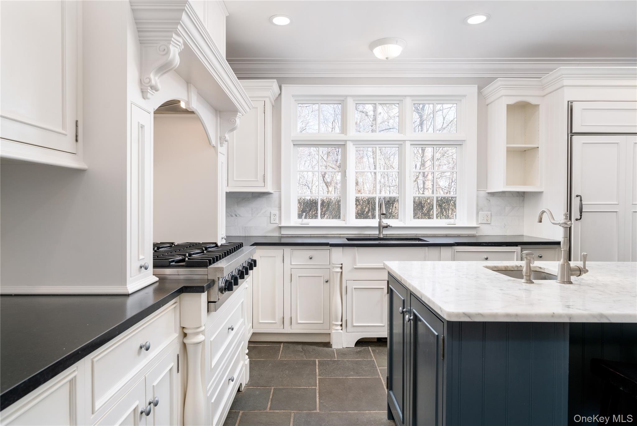 9 Old Field Road Setauket, NY 11733 - Photo 20 of 50 Chef's Kitchen With Custom Inset Cabinetry, Leathered Granite Counters, Marble Backsplash, Viking Professional Appliances, Center Island With Carrara Marble Counters, Radiant Heated Floors, And Breakfast Area Surrounded By Windows.