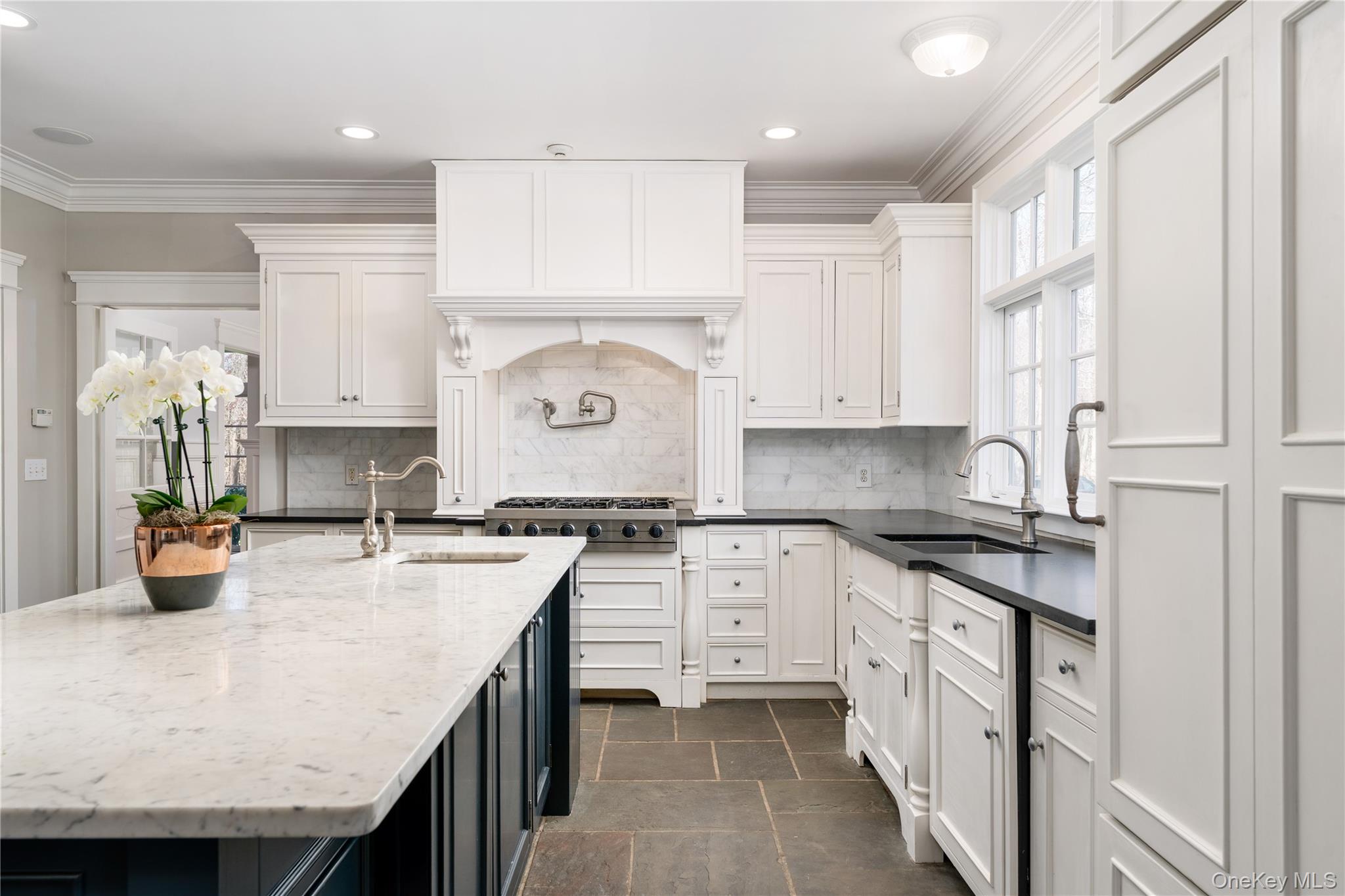 9 Old Field Road Setauket, NY 11733 - Photo 21 of 50 Chef's Kitchen With Custom Inset Cabinetry, Leathered Granite Counters, Marble Backsplash, Viking Professional Appliances, Center Island With Carrara Marble Counters, Radiant Heated Floors, And Breakfast Area Surrounded By Windows.