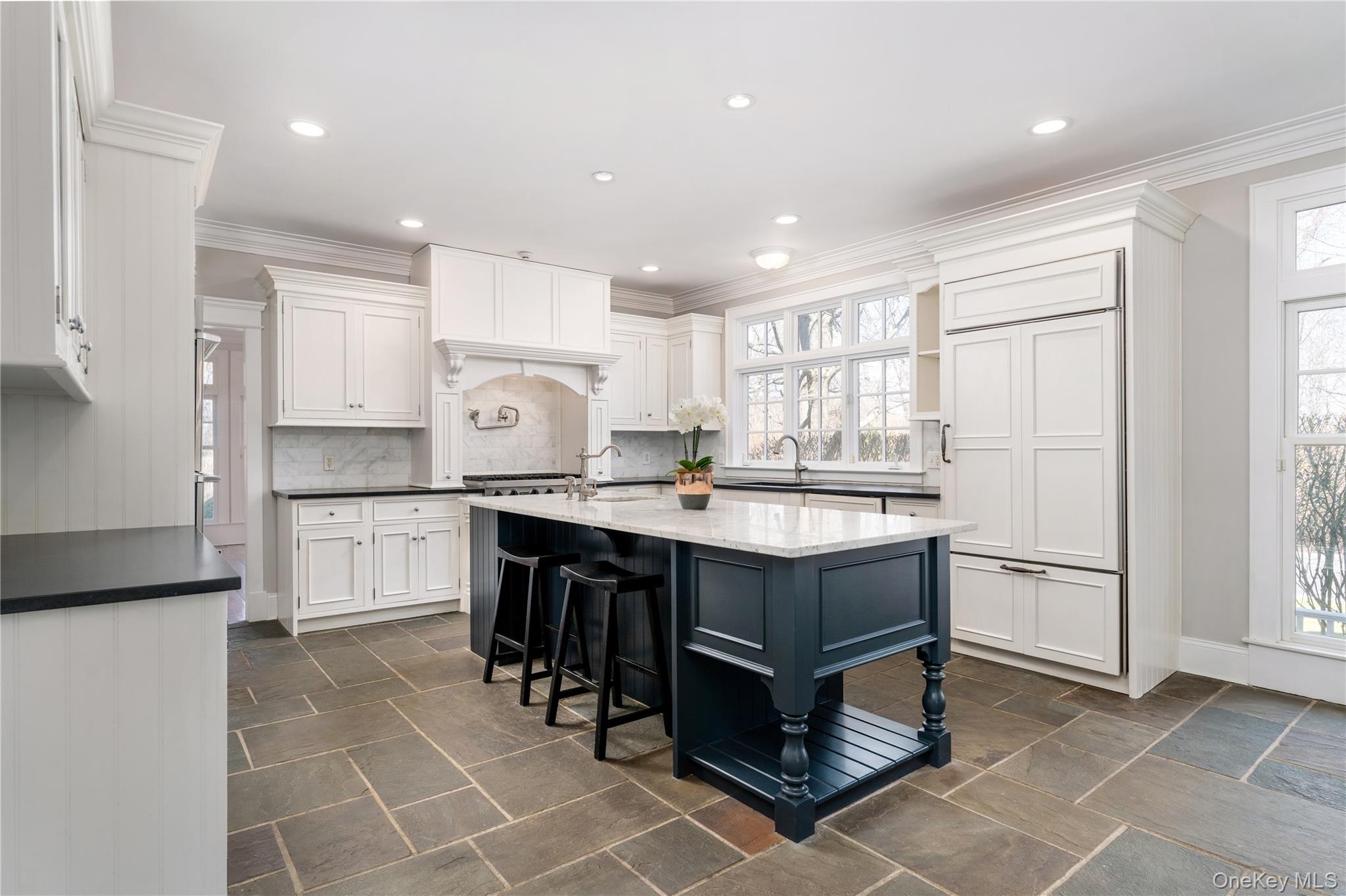9 Old Field Road Setauket, NY 11733 - Photo 22 of 50 Chef's Kitchen With Custom Inset Cabinetry, Leathered Granite Counters, Marble Backsplash, Viking Professional Appliances, Center Island With Carrara Marble Counters, Radiant Heated Floors, And Breakfast Area Surrounded By Windows.
