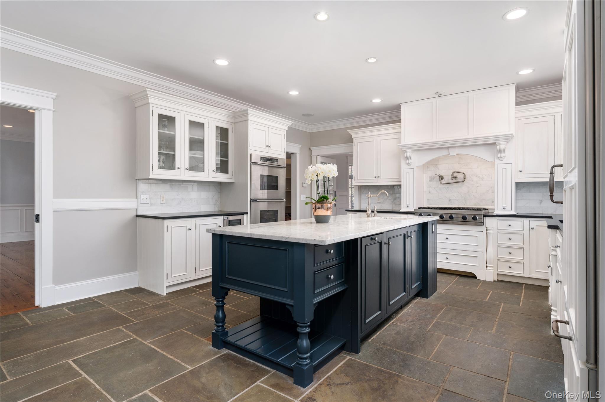 9 Old Field Road Setauket, NY 11733 - Photo 23 of 50 Chef's Kitchen With Custom Inset Cabinetry, Leathered Granite Counters, Marble Backsplash, Viking Professional Appliances, Center Island With Carrara Marble Counters, Radiant Heated Floors, And Breakfast Area Surrounded By Windows.