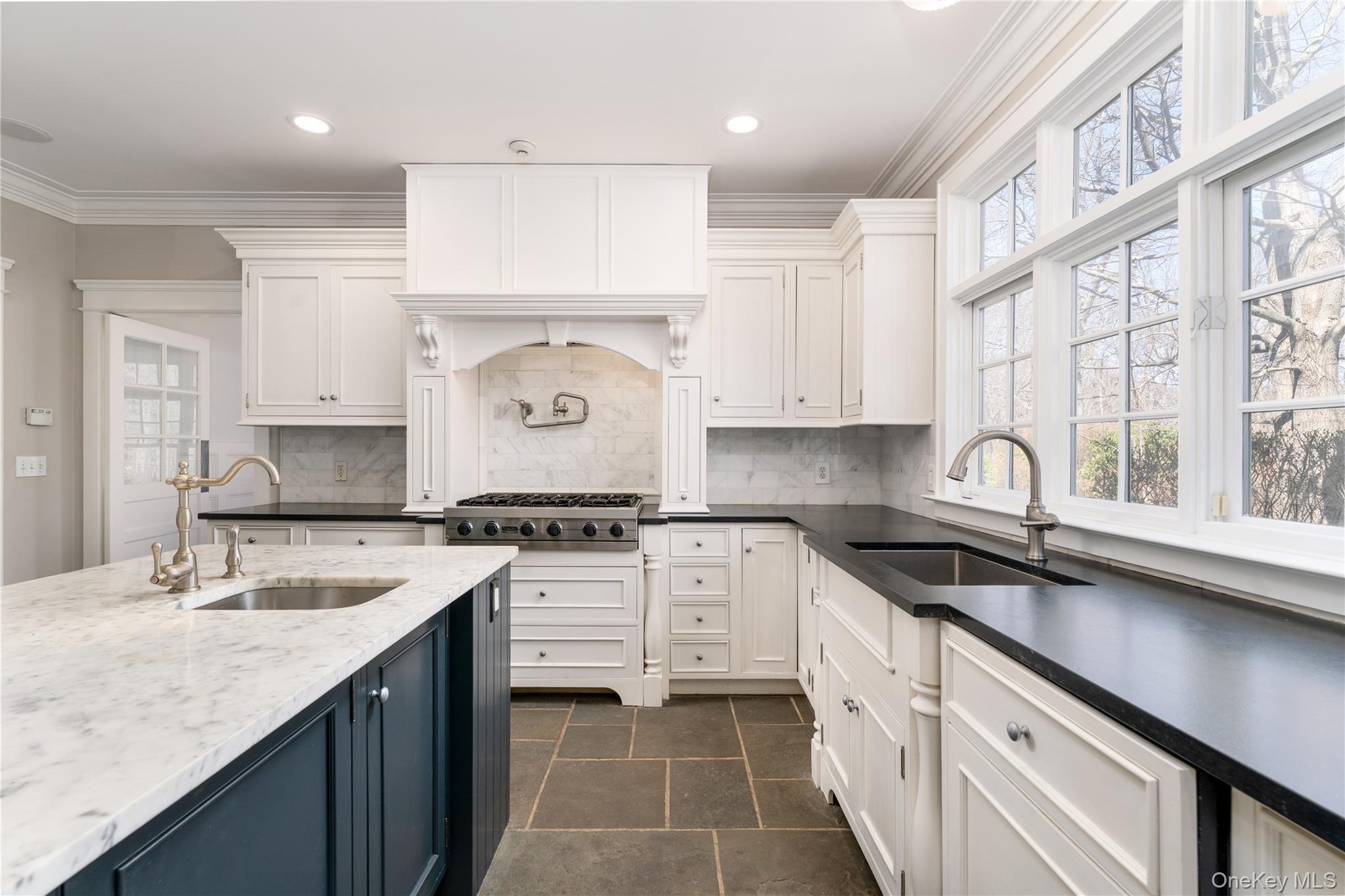 9 Old Field Road Setauket, NY 11733 - Photo 24 of 50 Chef's Kitchen With Custom Inset Cabinetry, Leathered Granite Counters, Marble Backsplash, Viking Professional Appliances, Center Island With Carrara Marble Counters, Radiant Heated Floors, And Breakfast Area Surrounded By Windows.