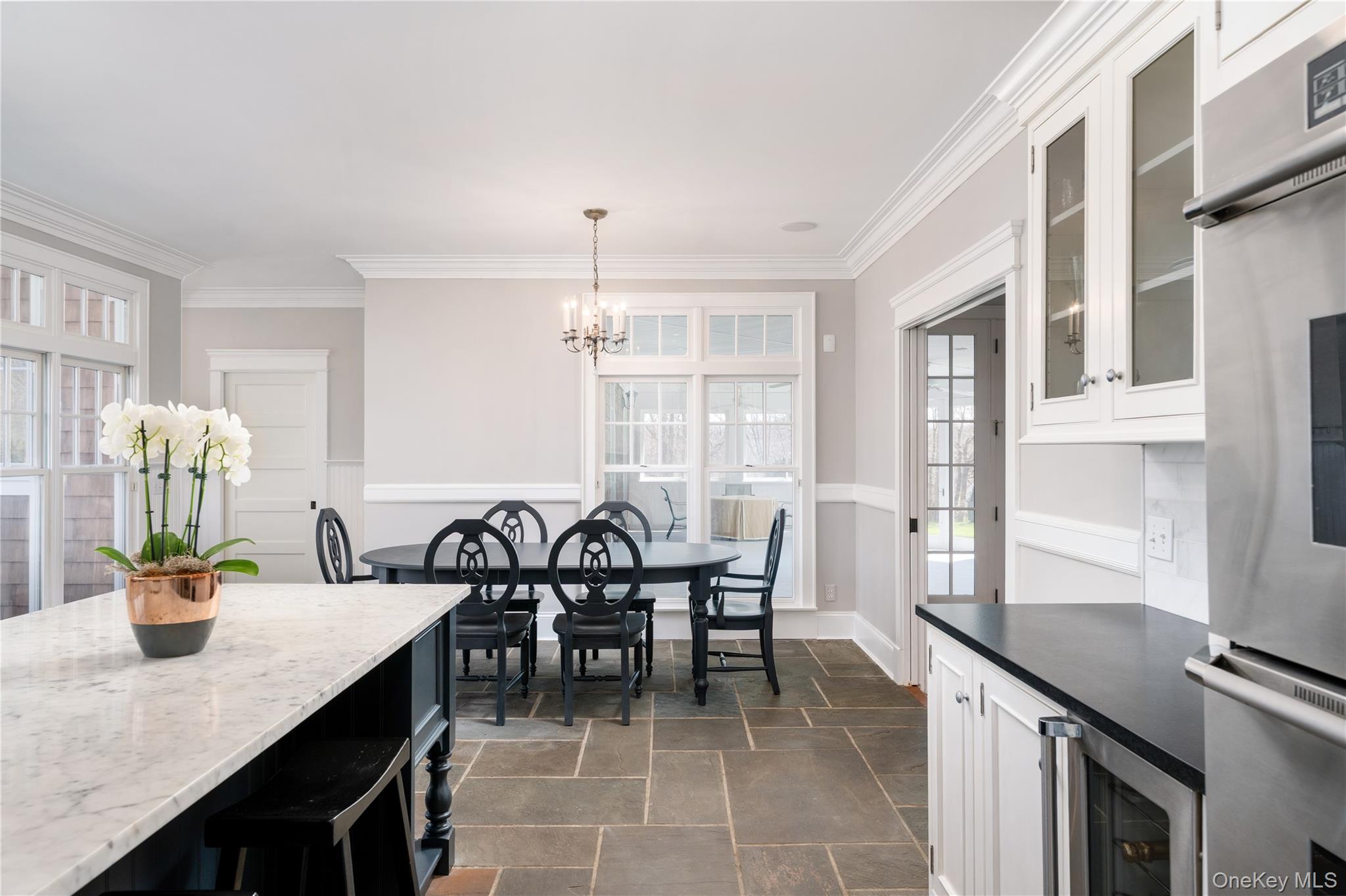 9 Old Field Road Setauket, NY 11733 - Photo 25 of 50 Chef's Kitchen With Custom Inset Cabinetry, Leathered Granite Counters, Marble Backsplash, Viking Professional Appliances, Center Island With Carrara Marble Counters, Radiant Heated Floors, And Breakfast Area Surrounded By Windows.