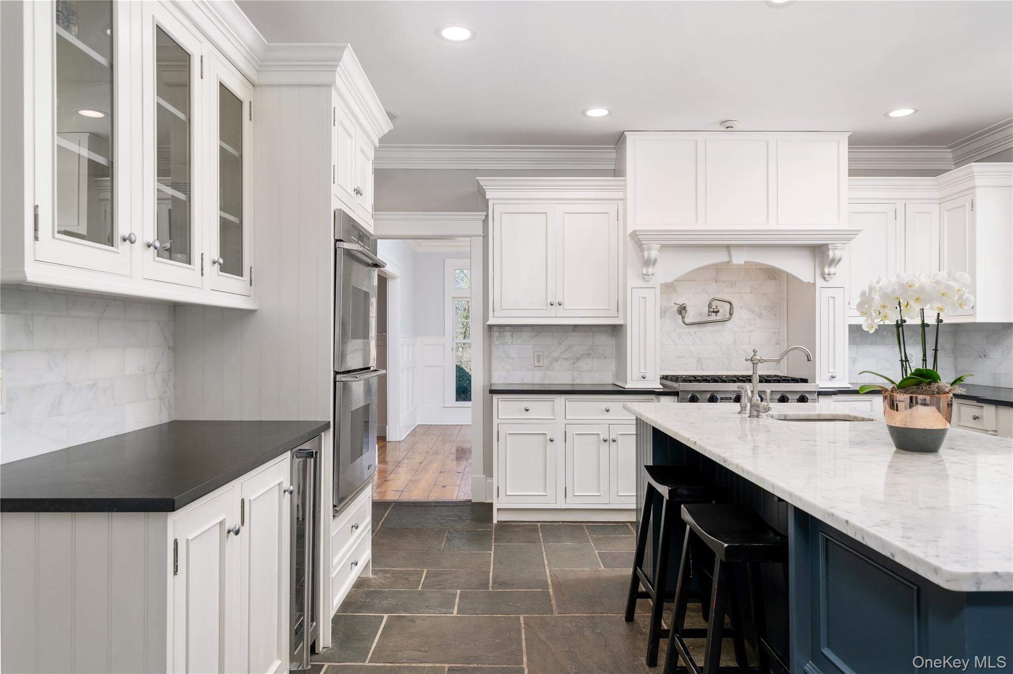 9 Old Field Road Setauket, NY 11733 - Photo 26 of 50 Chef's Kitchen With Custom Inset Cabinetry, Leathered Granite Counters, Marble Backsplash, Viking Professional Appliances, Center Island With Carrara Marble Counters, Radiant Heated Floors, And Breakfast Area Surrounded By Windows.