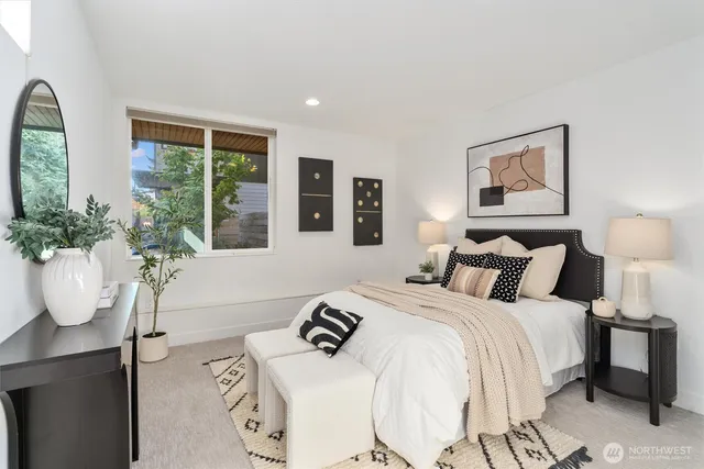 a bedroom with bed and windows