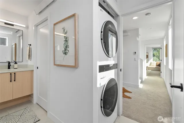 a view of a hallway with washer and dryer