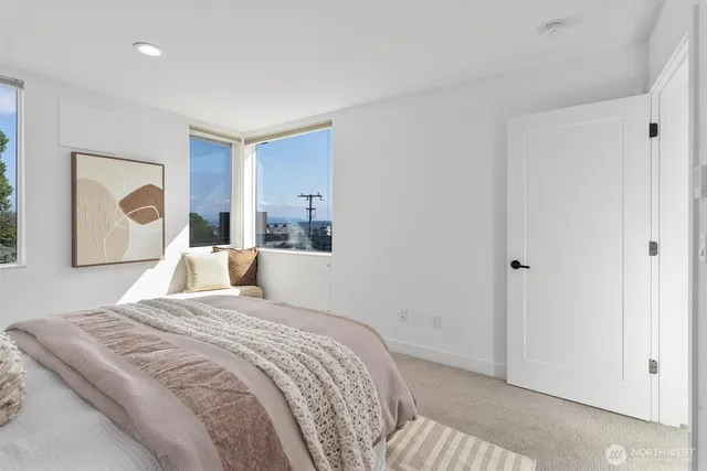 a bed room with a bed and a painting