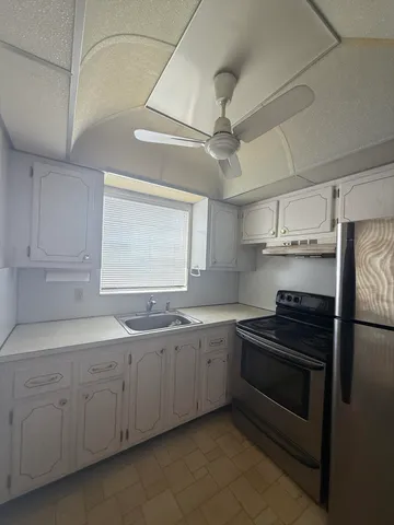 a kitchen that has a sink and cabinets