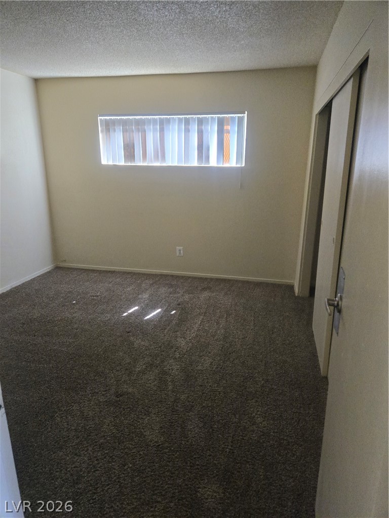 1388 East Desert Inn Road, Unit 2 Las Vegas, NV 89169 - Photo 14 of 23 This unfurnished bedroom offers soft carpeting and a window with blinds, creating a cozy and private atmosphere.