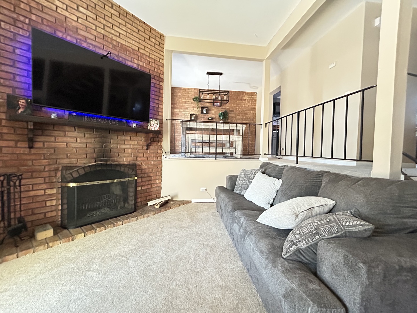 53 Mariner Lane North, Unit 53 Fox Lake, IL 60020 - Photo 11 of 30 a living room with furniture a flat screen tv and a fireplace