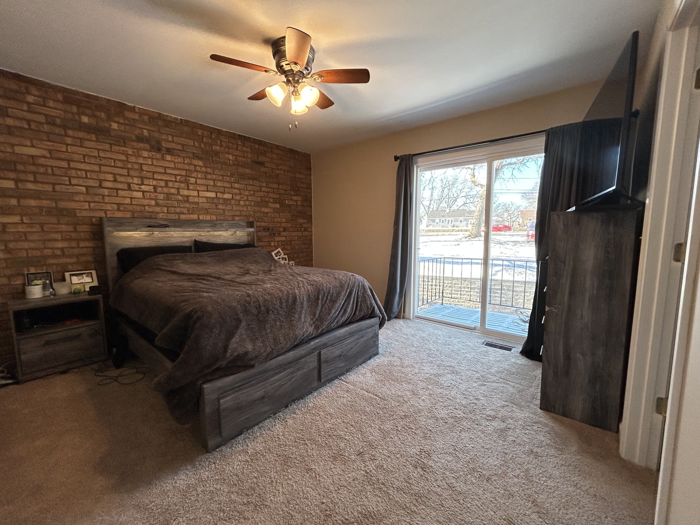 53 Mariner Lane North, Unit 53 Fox Lake, IL 60020 - Photo 14 of 30 a bedroom with a bed next to a window with a balcony