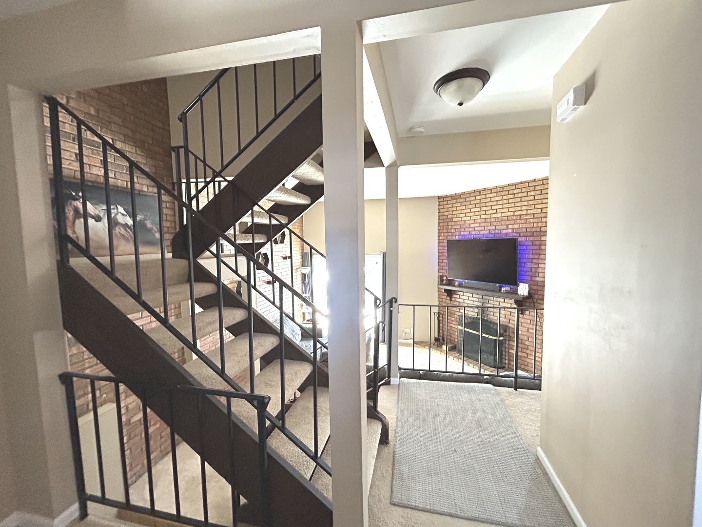 53 Mariner Lane North, Unit 53 Fox Lake, IL 60020 - Photo 2 of 30 a view of staircase with lots of frames on wall and a window