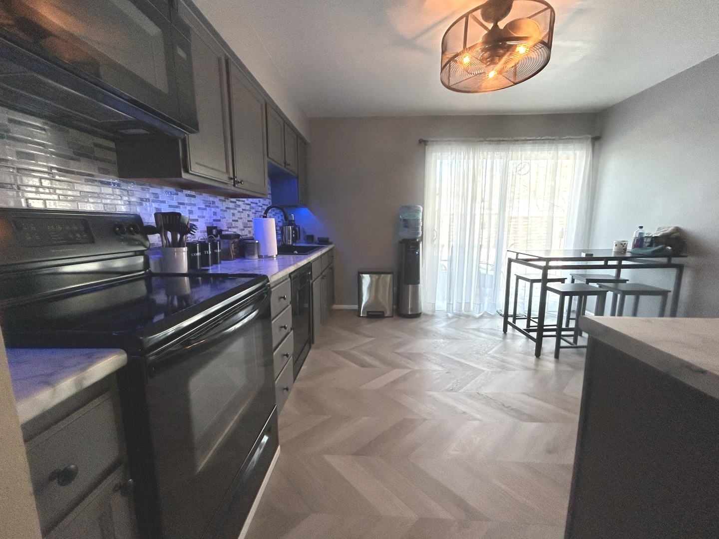 53 Mariner Lane North, Unit 53 Fox Lake, IL 60020 - Photo 6 of 30 a kitchen with stainless steel appliances granite countertop a stove a sink and a microwave