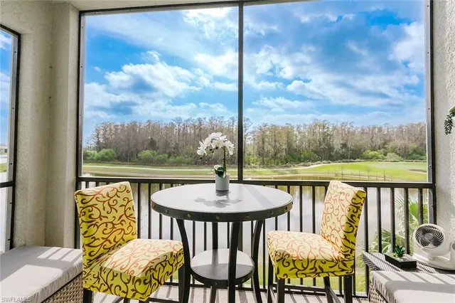 a view of a chairs and table in the balcony