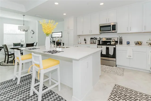 a kitchen with stainless steel appliances granite countertop a sink stove and cabinets