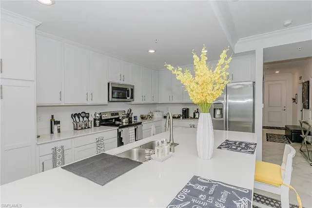 a large kitchen with a table and chairs