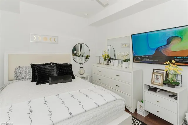 a bathroom with a sink a toilet a mirror and shower curtain