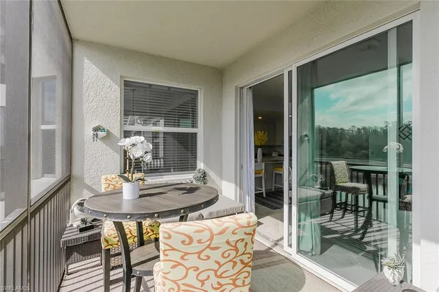 a view of a swimming pool with an outdoor seating