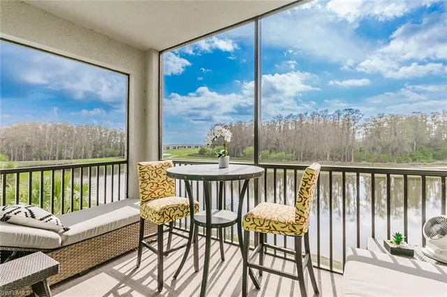 a view of a chair and tables in the balcony