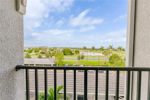 a view of a balcony with wooden floor and ocean view