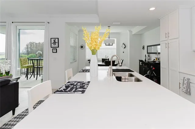 a kitchen with stainless steel appliances kitchen island granite countertop a sink and cabinets