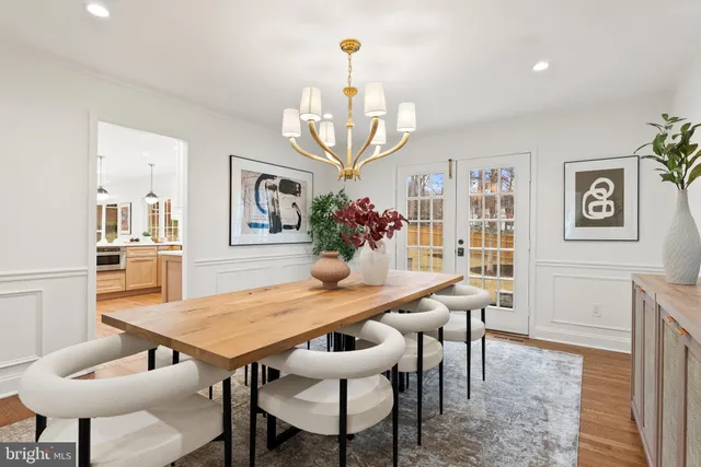 a view of a dining room with furniture and chandelier