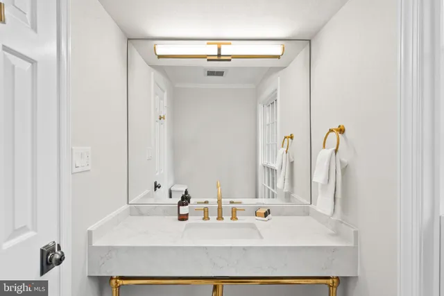 a bathroom with a sink mirror vanity and toilet
