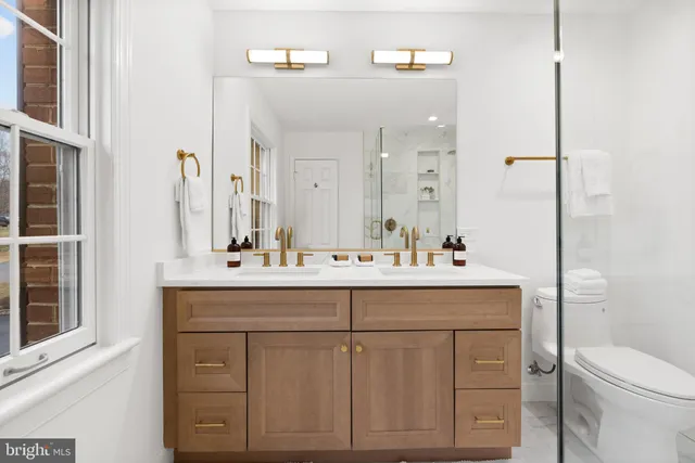 a bathroom with a sink mirror toilet and bathtub