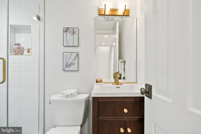 a kitchen with white cabinets and sink