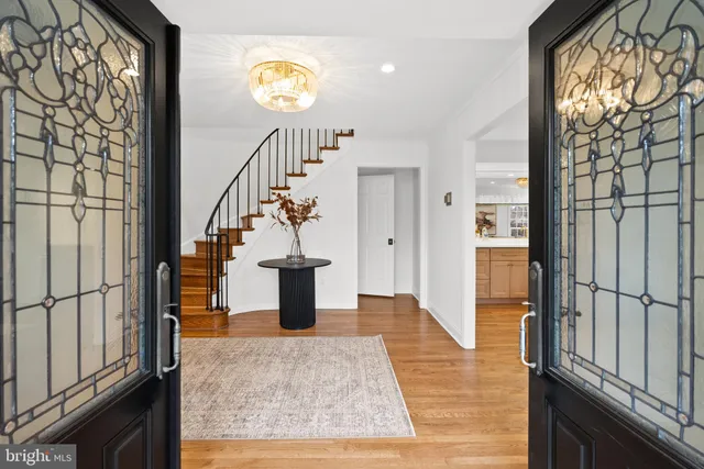 a view of entryway and hall with wooden floor