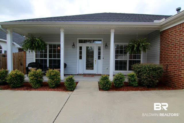 7263 Highpointe Place East Daphne, AL 36527 - Photo 9 of 22 Home features a covered porch and beautiful door and landscaping!
