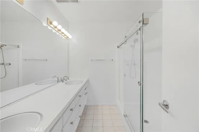 a bathroom with a double vanity sink a and mirror