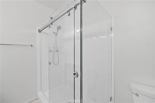 a bathroom with a glass shower door