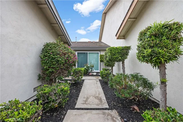 a view of a pathway with house plants
