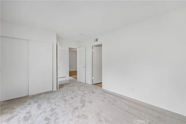 a view of an empty room and closet area