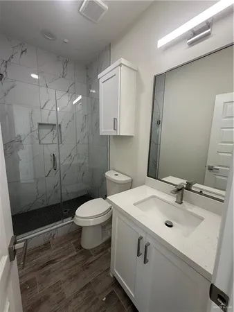a bathroom with a sink toilet and shower
