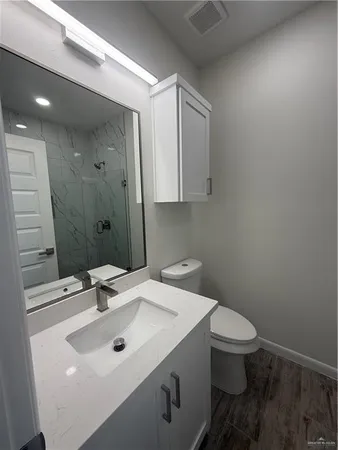 a bathroom with a sink toilet and mirror