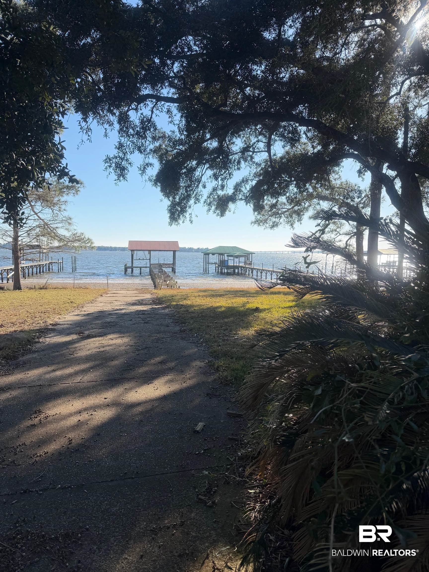 35776 Boykin Boulevard Lillian, AL 36549 - Photo 1 of 14 View of yard featuring a water view and a dock