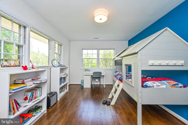 a living room with furniture and a book shelf