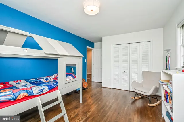 a bedroom with furniture and a wooden floor