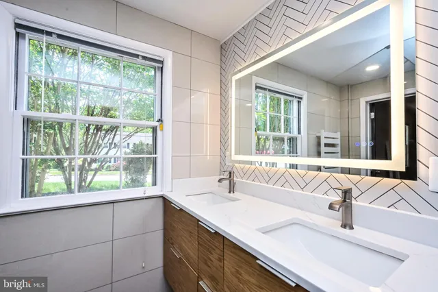 a bathroom with a sink and a large window
