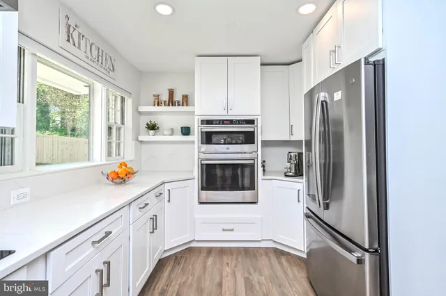 a kitchen with stainless steel appliances a refrigerator sink and cabinets