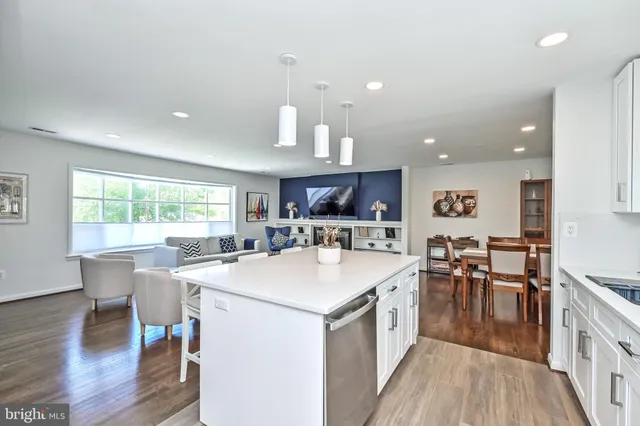 a large kitchen with a table and chairs
