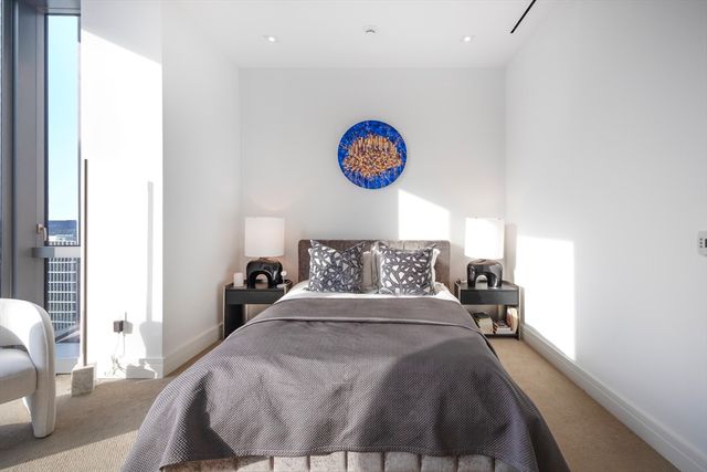 a bed room with a bed and a chair