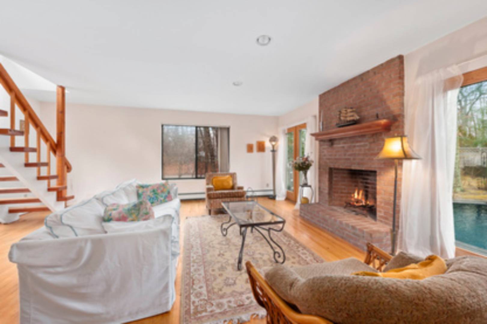 141 Roses Grove Road Southampton, NY 11968 - Photo 2 of 10 a living room with furniture and a fireplace