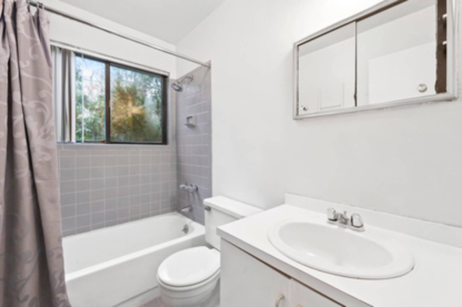 141 Roses Grove Road Southampton, NY 11968 - Photo 8 of 10 a bathroom with a sink a toilet and bathtub