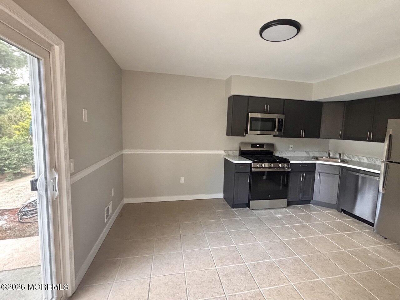 1144 Sawmill Road, Unit 121 Brick, NJ 08724 - Photo 9 of 23 a kitchen with a refrigerator and a sink