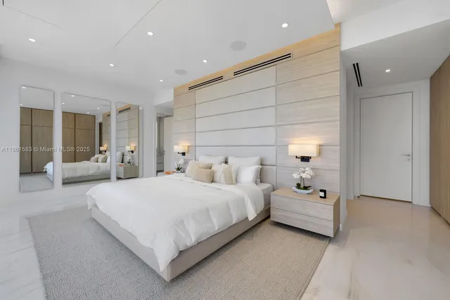 a large bedroom with a bed and lamp